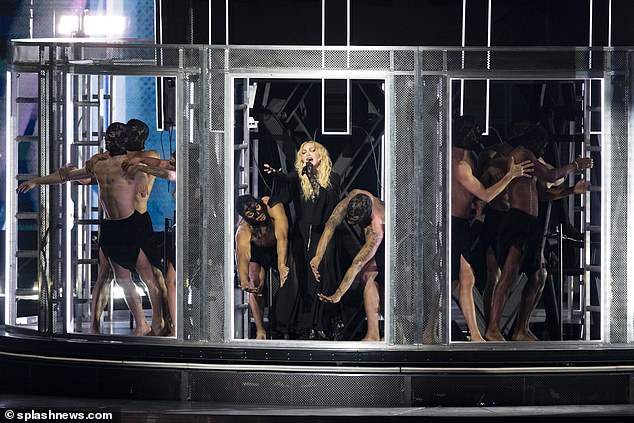 Baring it all: Madonna was surrounded by topless dancers - men and women alike