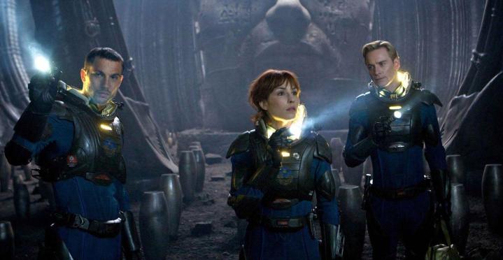Three astronauts stand in an abandoned area in Prometheus.