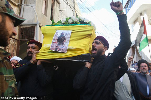 Members and supporters of Hezbollah take part in the funeral of Kamal al-Masri, one of the group's fighters, in Burj al-Shemali town east of Tyre in southern Lebanon on October 2015, after he reportedly died of injuries sustained in cross-border fire with Israel. Lebanon's Hezbollah and Israel exchanged deadly border fire on October 15, with the Iran-backed group claiming responsibility for strikes that Israel said killed a civilian, further raising cross-border tensions during Israel's war with Gaza-based militants. (Photo by Mahmoud ZAYYAT / AFP) (Photo by MAHMOUD ZAYYAT/AFP via Getty Images)