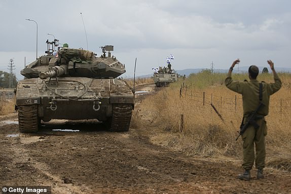 NEAR AMIAD, ISRAEL - OCTOBER 15:  Israeli armor personnel carriers move in formation near the Israeli border with Lebanon on October 15, 2023 Near Amiad , Israel. Israel has sealed off Gaza and launched sustained retaliatory air strikes, which have killed at least 1,400 people with more than 400,000 displaced, after a large-scale attack by Hamas. On October 7, the Palestinian militant group Hamas launched a surprise attack on Israel from Gaza by land, sea, and air, killing over 1,300 people and wounding around 2,800. Israeli soldiers and civilians have also been taken hostage by Hamas and moved into Gaza. The attack prompted a declaration of war by Israeli Prime Minister Benjamin Netanyahu and the announcement of an emergency wartime government.  (Photo by Amir Levy/Getty Images) *BESTPIX*