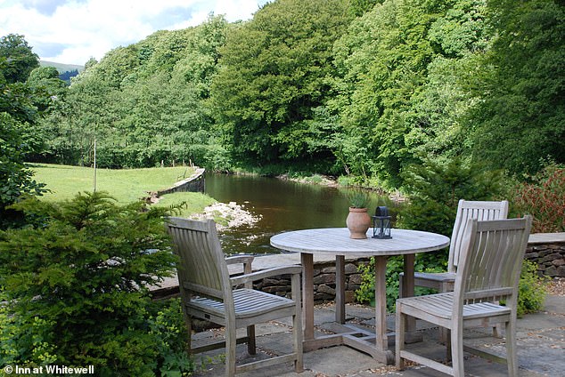 The Inn at Whitewell in Lancashire (above), which overlooks the River Hodder, takes the title of Britain's best pub with rooms