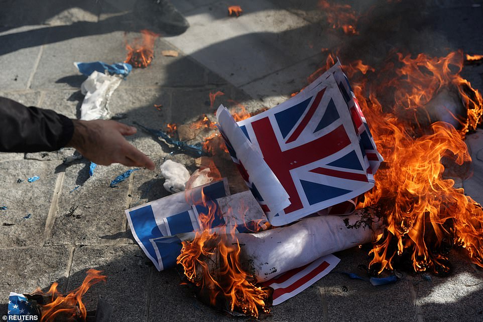 TURKEY: Demonstrators set fire on makeshift Israeli and British flags during a protest against Israel as the conflict between Israel and Hamas continues, in Istanbul on Friday