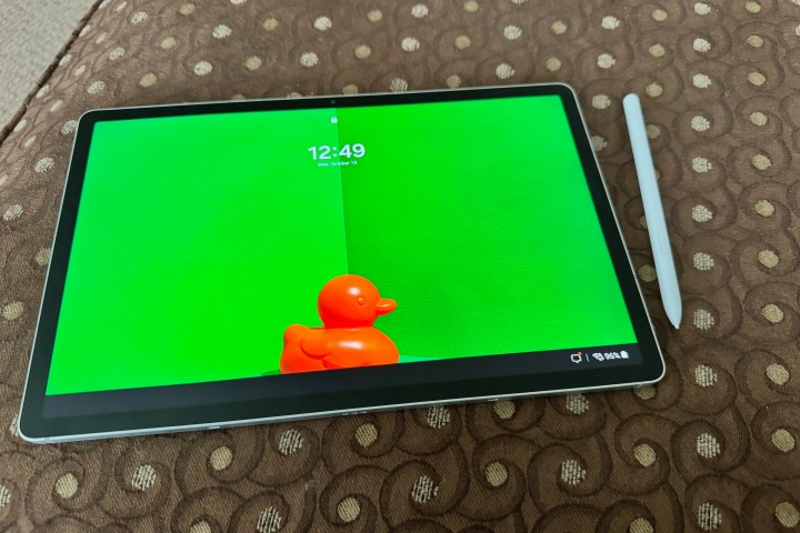 A Samsung Galaxy Tab S9 FE+ showing off itself on a piece of furniture with an S Pen nearby.