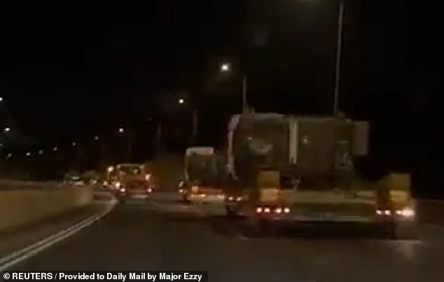 Israeli military convoys are seen on the move near the Gaza Strip in the early hours of Friday