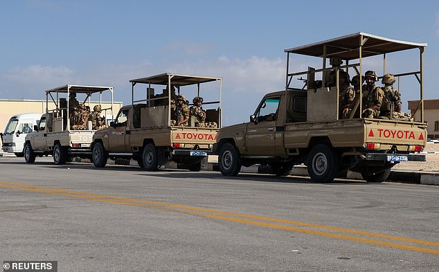 Egyptian members of the military sit in trucks as humanitarian aid from for Palestinians waits for the reopening of the Rafah border crossing on the Egyptian side to enter Gaza on Friday