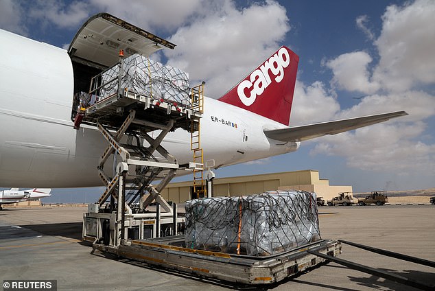 A view of humanitarian aid for Palestinians next to a plane, as officials wait to deliver aid to Gaza through the Rafah border crossing between Egypt and the Gaza Strip on Friday at Al Arish airport, Egypt