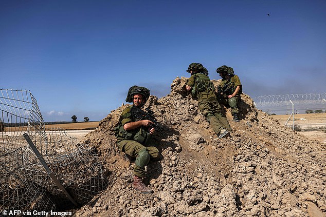 Israeli soldiers are positioned outside Kibbutz Beeri near the border with the Gaza Strip on October 20, 2023, amid the ongoing battles between Israel and the Palestinian group Hamas. Thousands of people, both Israeli and Palestinians have died since October 7, 2023