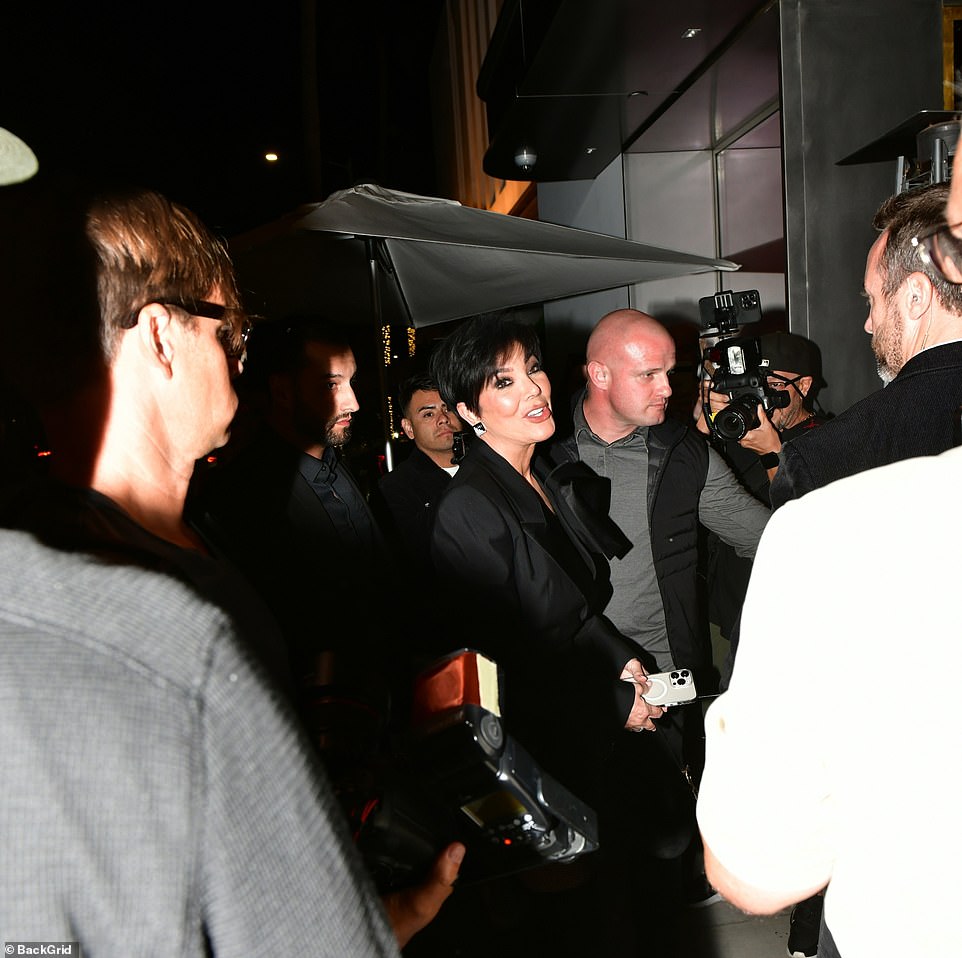 She looked in high spirits while chatting with photographers outside the restaurant