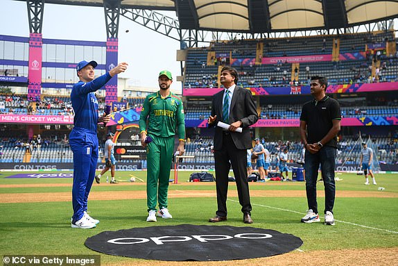 MUMBAI, INDIA - OCTOBER 21: Jos Buttler of England flips the coin as Aiden Markram of South Africa looks on prior to the ICC Men's Cricket World Cup India 2023 match between England and South Africa at Wankhede Stadium on October 21, 2023 in Mumbai, India. (Photo by Alex Davidson-ICC/ICC via Getty Images)