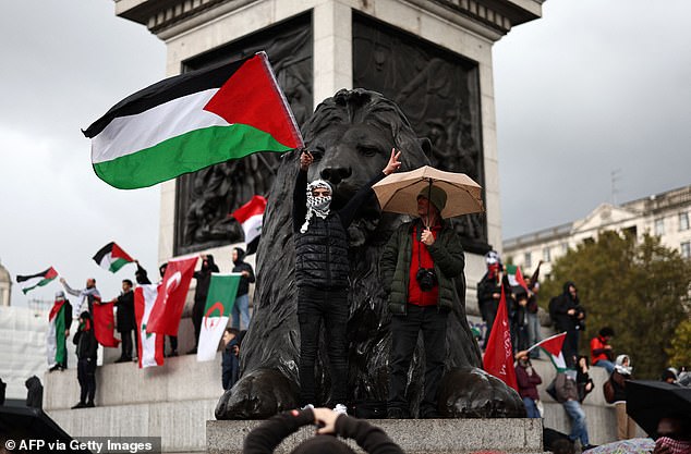 People stand in Trafalgar Square as they take part in a 'March For Palestine'