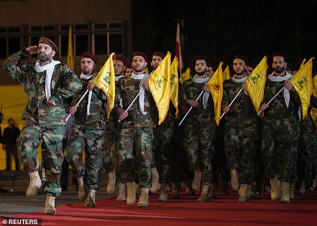 Members of Hezbollah march with party's flags during a rally marking al-Quds Day in 2019