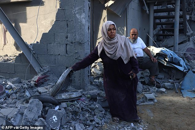 Palestinians inspect the damage after overnight Israeli strikes on Rafah in the southern Gaza Strip