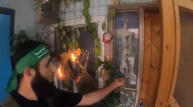 One Hamas terrorist is seen holding his lighter to house plants and hanging ornaments in an Israeli that quickly set ablaze before they made their exit