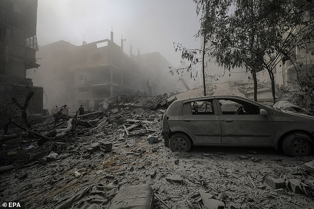 Buildings are reduced to rubble and smoke fills the air in Gaza City, 23 October 2023