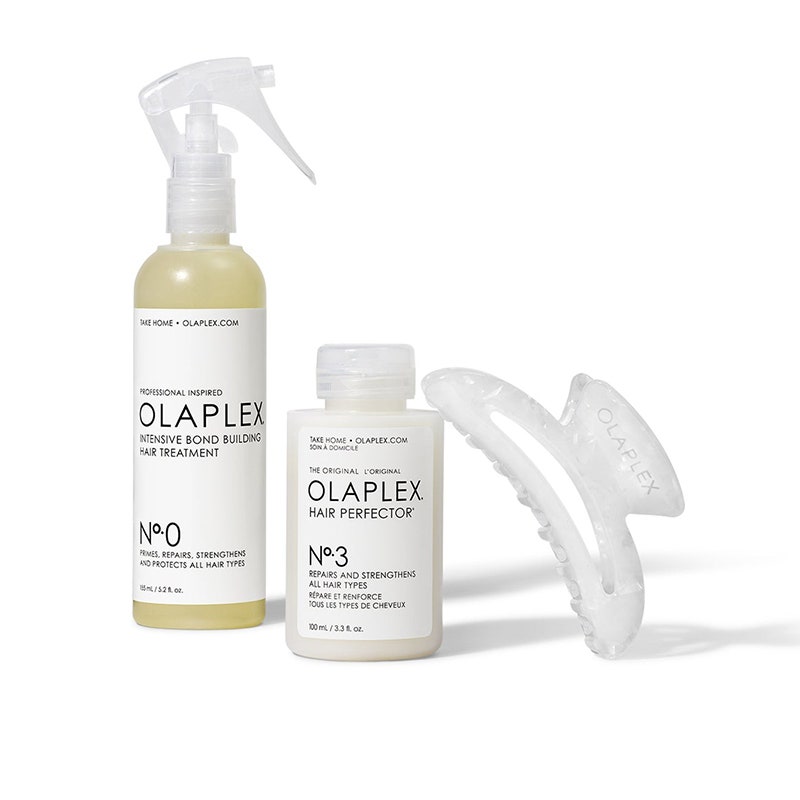 Olaplex Das ultimative Reparaturset: Eine weiße Sprühflasche, eine Flasche mit Deckel und eine Haarklammer auf weißem Hintergrund