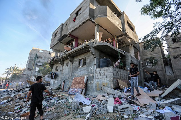 People search through buildings that were destroyed during Israeli air raids in the southern Gaza Strip on Monday in Khan Yunis, Gaza