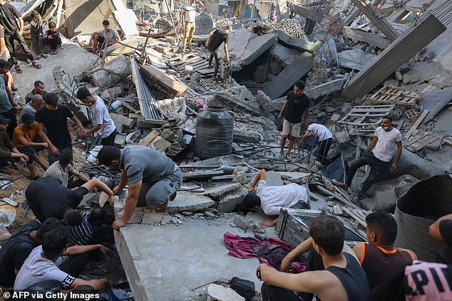 Palestinians look for survivors in the rubble of a building following Israeli bombing in Rafah in the southern Gaza Strip on Tuesday