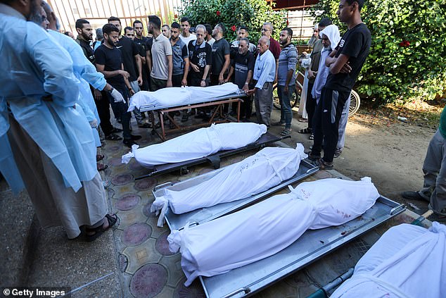 People mourn as they collect the bodies of Palestinians killed in Israeli air raids on Tuesday in Khan Yunis