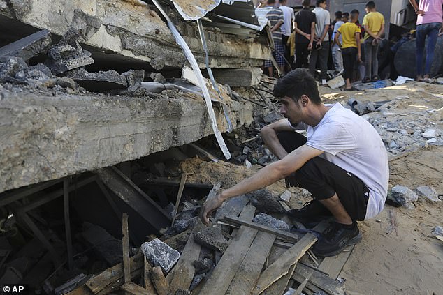 Palestinians look for survivors after an Israeli strike in Rafah, Gaza Strip, on Tuesday