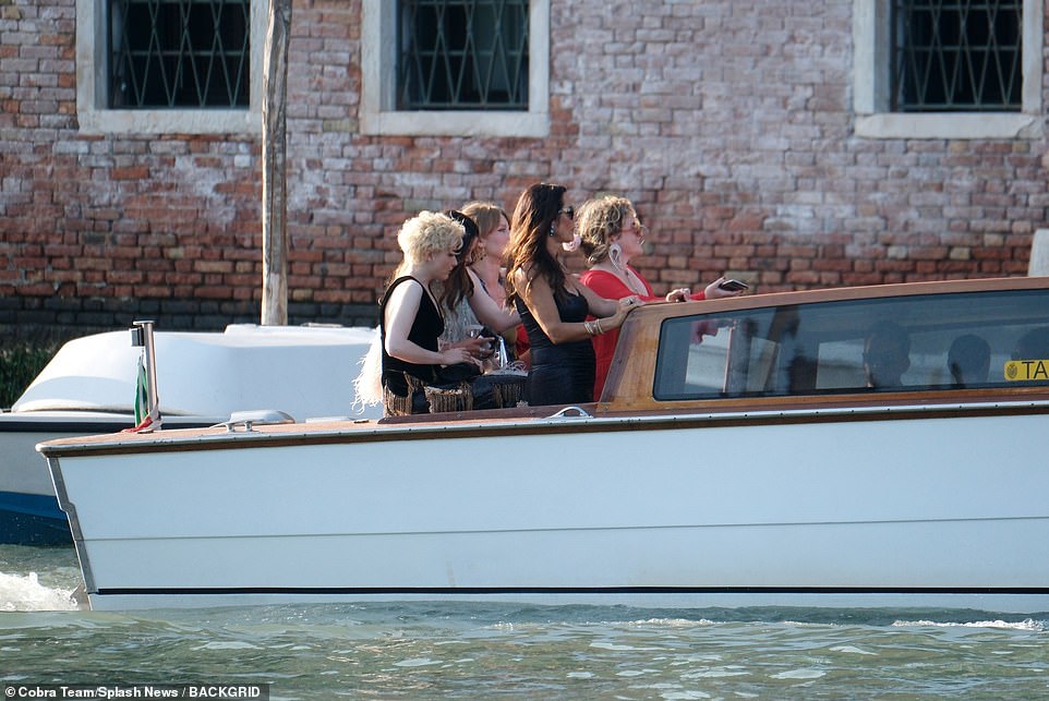 Here the come: The group stood in the rear of their water taxi as it made its way across the Grand Canal in Venice