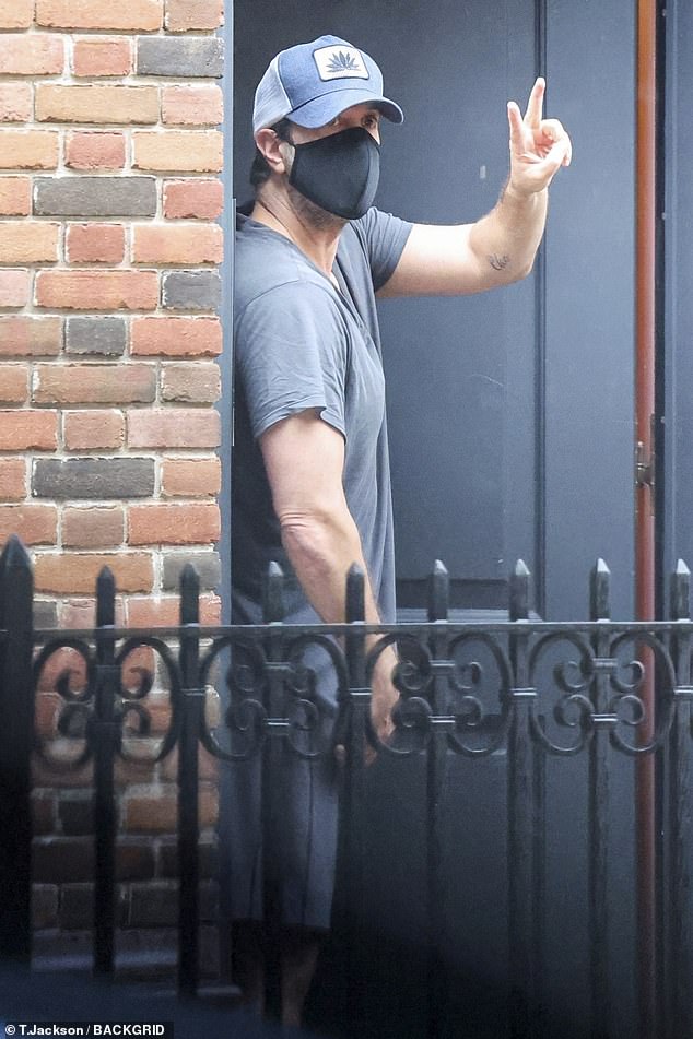 David Schwimmer looked downbeat on Sunday but he managed to flash a peace sign as he was spotted collecting a Chinese food delivery at home in New York City
