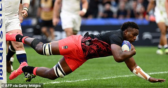 Fiji's number eight Viliame Mata dives and scores his team's first try   during the France 2023 Rugby World Cup quarter-final match between England and Fiji at the Velodrome Stadium in Marseille, southeastern France, on October 15, 2023. (Photo by CHRISTOPHE SIMON / AFP) (Photo by CHRISTOPHE SIMON/AFP via Getty Images)