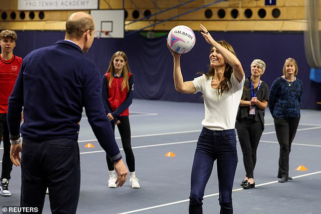 The Princess of Wales, who is known for her competitive streak, beamed as she tried to score a goal while Prince William defended the net