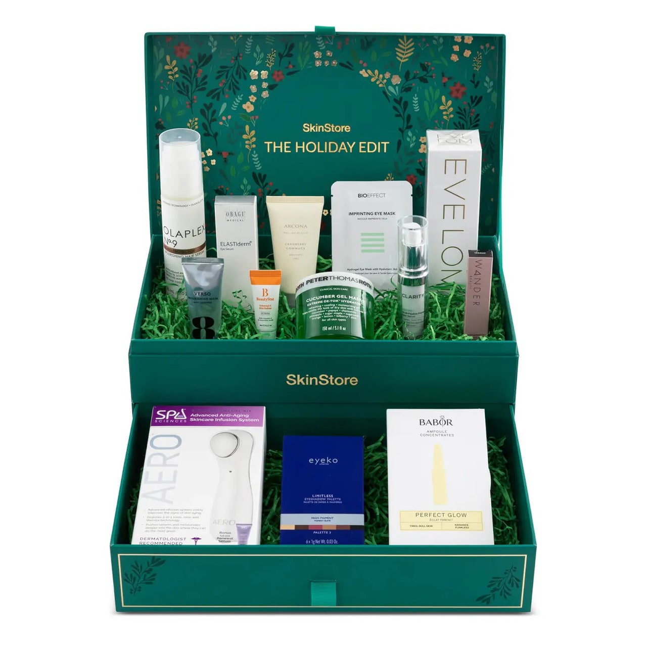 Die grüne SkinStore Holiday Edit-Box mit Hautpflegeprodukten im Urlaubsthema auf weißem Hintergrund