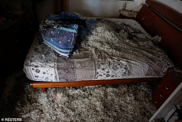 Pillow feathers cover the area at a destroyed home, following the deadly Oct. 7 attack by Hamas gunmen from the Gaza Strip, in Kibbutz Kissufim, southern Israel, on Tuesday