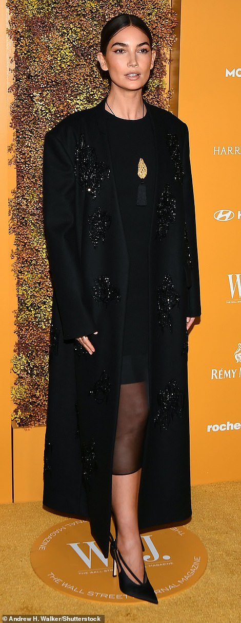 All black: Lily Aldridge, 37, looked chic in a black coat with sparkling sequin details, worn over a classy black dress
