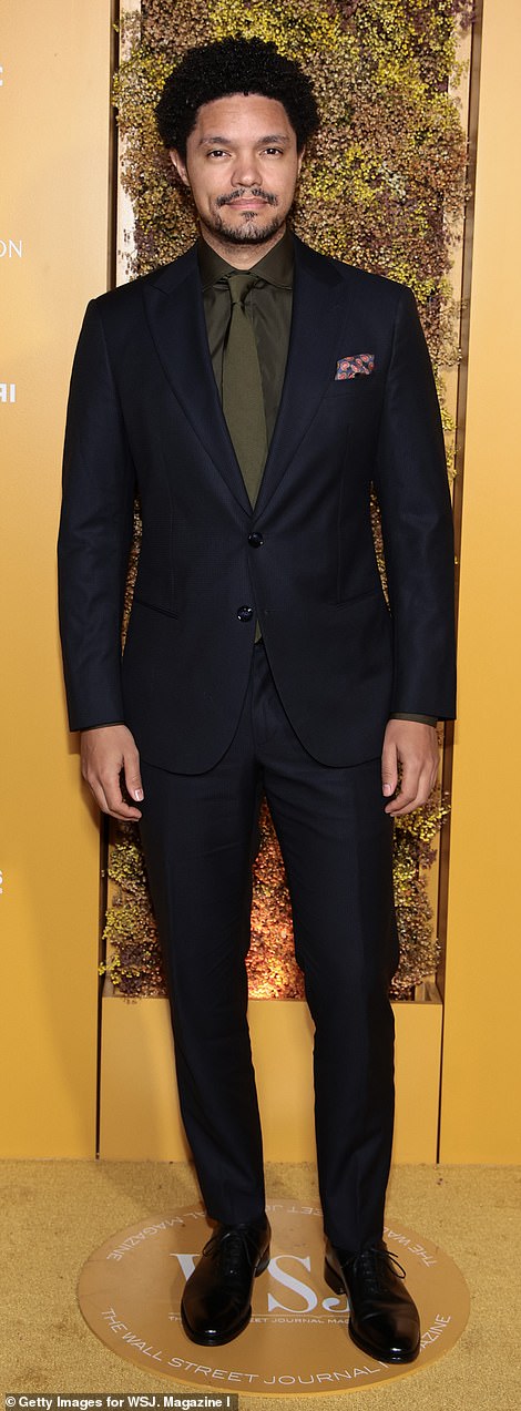 Handsome: Trevor Noah, 39, looked handsome in a navy suit and an olive green tie