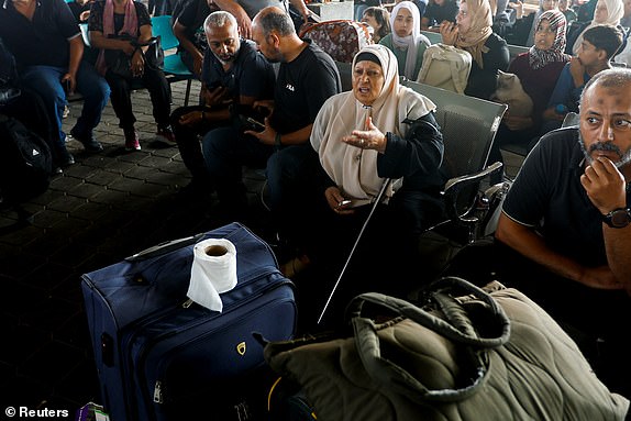 A woman reacts as Palestinians with dual citizenship wait for permission to leave Gaza, amid the ongoing conflict between Israel and Palestinian Islamist group Hamas, at the Rafah border crossing with Egypt, in Rafah in the southern Gaza Strip, November 2, 2023. REUTERS/Ibraheem Abu Mustafa