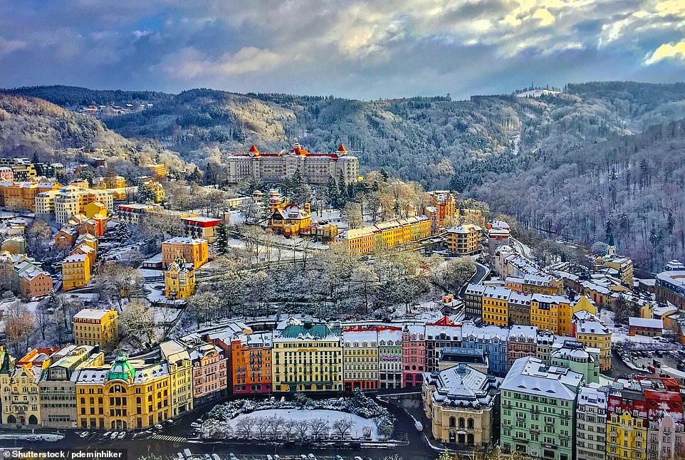 Shown covered in frost in this picture, the spa town of Karlovy Vary sits in the west Bohemia region of the Czech Republic. 'Day trippers come to admire the grand 19th-century spa architecture and to stroll the impressive colonnades, sipping on the supposedly health-restoring sulphurous waters from spouted ceramic drinking cups,' Lonely Planet says of the town