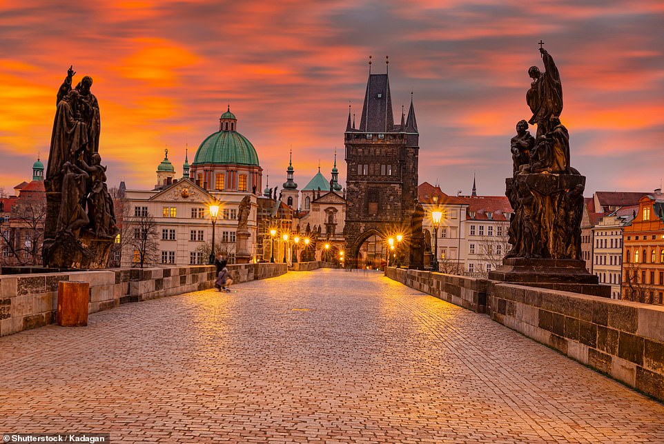 In this magical shot, the sun sets over Charles Bridge in Prague, the Czech capital. The bridge, which arches over the Vltava River, was completed in the 15th century and is a popular tourist spot today. There's a lucky charm to be discovered along the bridge - it's said to bring good fortune if you rub the plaque that sits beneath the statue St John of Nepomuk, local travel blog Prague.net reveals