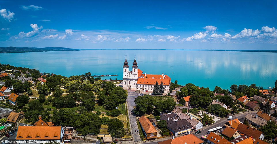 This image shows the picturesque village of Tihany, which lies on the northern shore of Hungary's Lake Balaton. Lonely Planet notes that the village 'is home to the celebrated Abbey Church, and in the height of summer the church attracts so many people it’s hard to find space to breathe'. It advises: 'Visit the church, but then escape the madness by wandering around the tiny town that's filled with lovely thatched-roof houses'