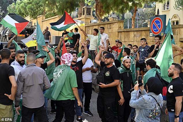 Palestinian activists shout slogans during a march to express solidarity with Palestinians in Gaza outside of the British embassy in downtown Beirut, Lebanon, 13 October 2023