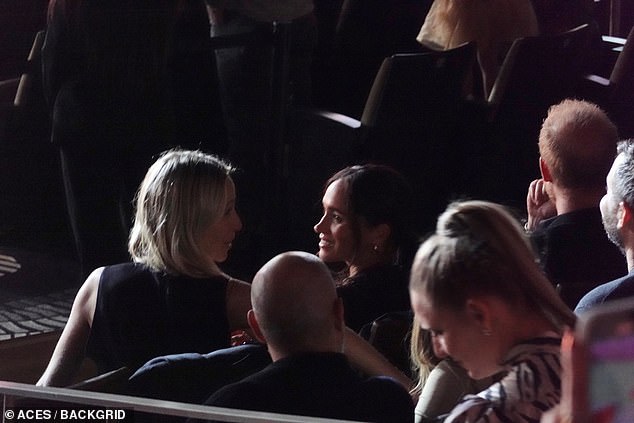 The Duchess looked to make small talk during the concert, smiling at other guests while she chatted