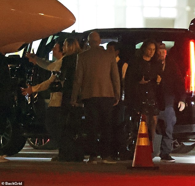 Another photo shows Meghan exiting a jet after the Katy Perry gig, with Madden just behind her