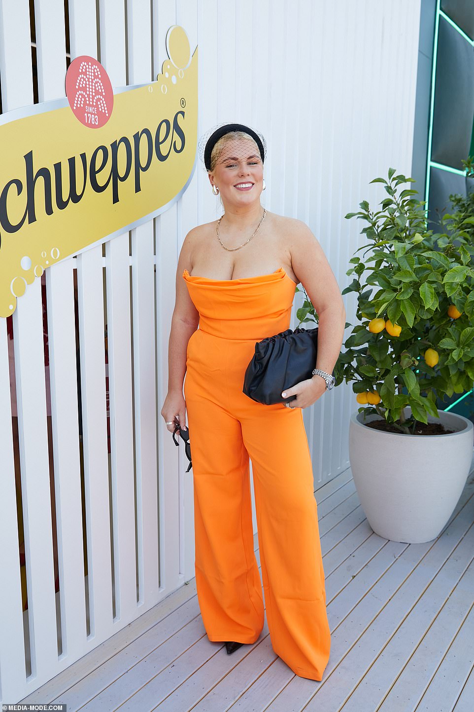 Shane Warne's daughter Brooke also dared to bare in a plunging tangerine jumpsuit