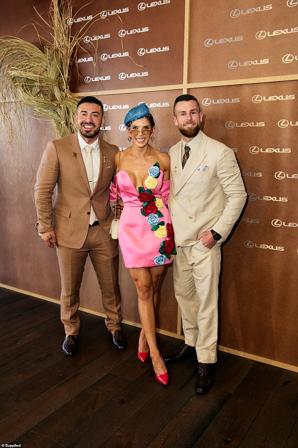ACERO gym co-founder Amy Castano meanwhile stunned in a pink frock embellished with colourful flowers. She posed for photos arm-in-arm with her ex-husband and ACERO gym co-founder Jono Castano (left) and her soccer star boyfriend Aaron Evans (right)