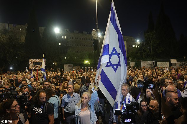 People in Jerusalem observe a moment of silence on Tuesday night as they commemorate one month since the October 7 terror attack carried out by Hamas