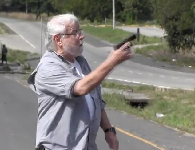 Darlington was seen in footage pulling a gun from his pocket and waving it in front of the protesters as he got into a heated argument with them in the middle of the road