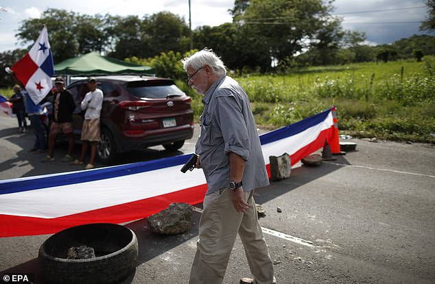 Darlington is seen holding a handgun after walking up to a teachers' blockade on the Pan-American Highway in Chame, Panama