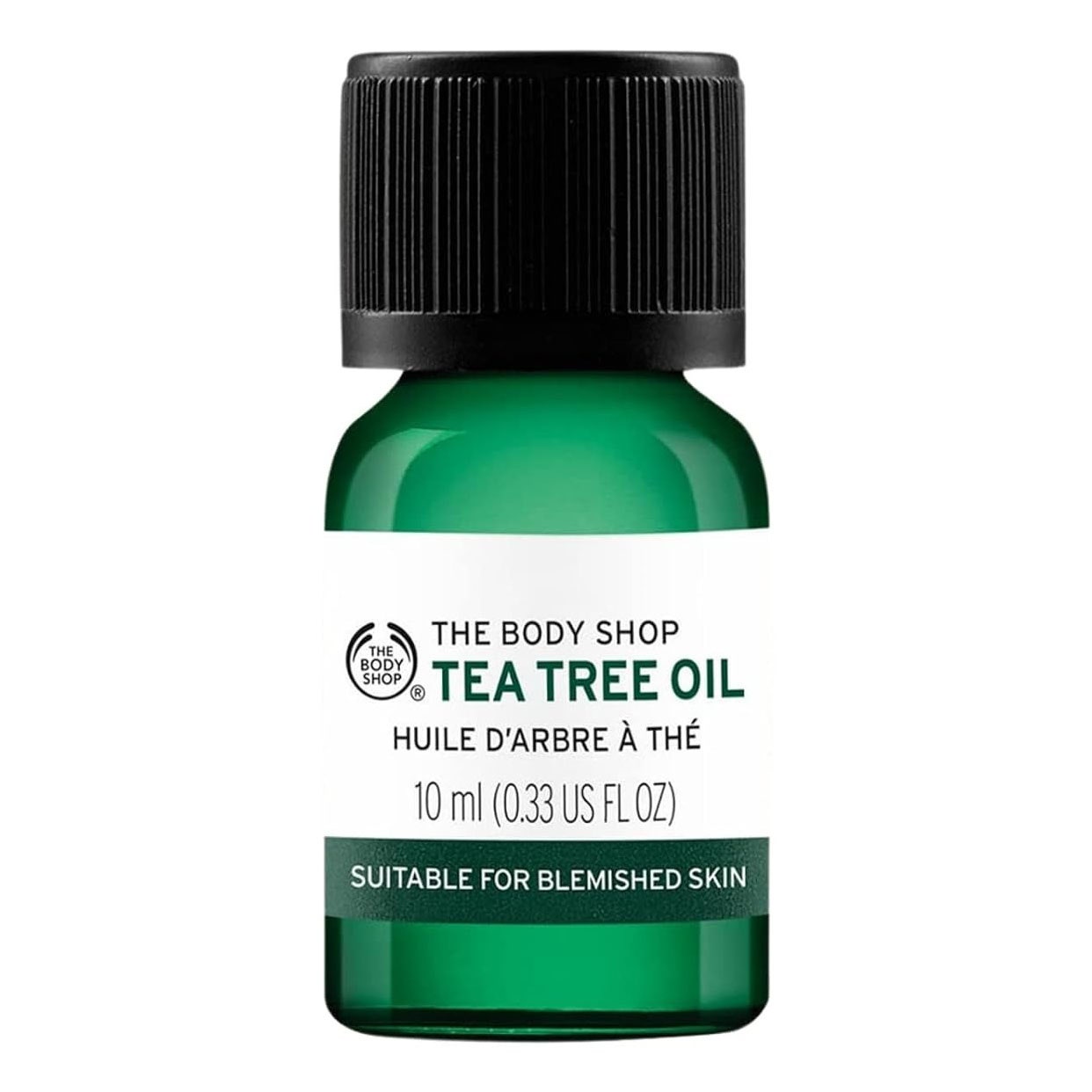 Das Body Shop Teebaumöl in grüner Glasflasche auf weißem Hintergrund
