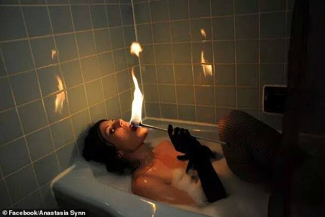 Anastasia Synn, Zauberin, Stunt-Darstellerin und Biohackerin, führt im Bad eine schreckliche Feuerfress-Aktion vor