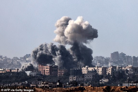 TOPSHOT - This picture taken from the Israeli side of the border with the Gaza Strip on November 10, 2023, shows smoke rising above buildings during an Israeli strike on the northern part of the Palestinian enclave, amid ongoing battles between Israel and the Palestinian Hamas movement. (Photo by Jack Guez / AFP) (Photo by JACK GUEZ/AFP via Getty Images)