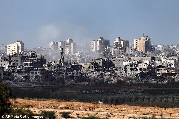 TOPSHOT - A picture taken from Sderot along the border with the Gaza Strip, shows smoke rising behind destroyed buildings in the Palestinian enclave during an Israeli strike, amid ongoing battles between Israel and the Palestinian Hamas movement, on November 10, 2023. (Photo by Jack Guez / AFP) (Photo by JACK GUEZ/AFP via Getty Images)