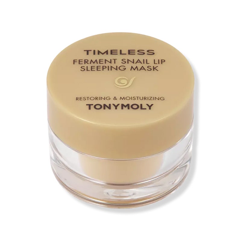 Tonymoly Timeless Ferment Snail Lip Sleeping Mask: Ein klares Glas mit beigem Deckel und schwarzem Text auf weißem Hintergrund