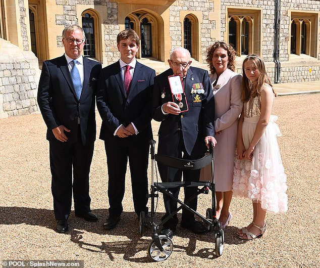 Kapitän Tom erhält seine Ritterschaft zusammen mit seiner Tochter Hannah (zweite von links), Colin Ingram-Moore (links) und seinen Enkelkindern Benji und Georgia auf Schloss Windsor