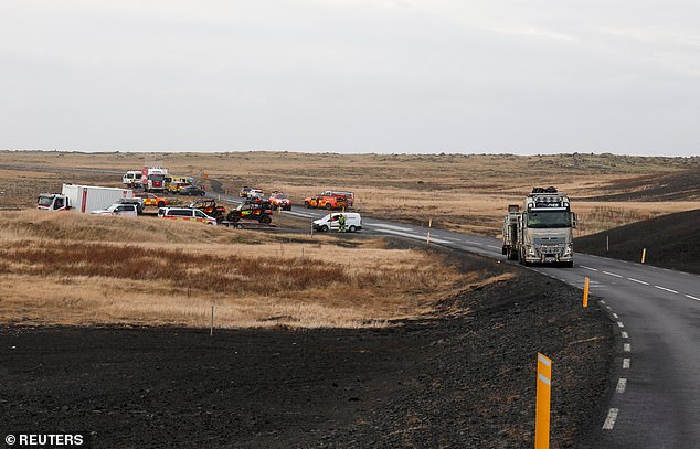 Emergency vehicles gathered on a road leading towards Grindavik, which was evacuated due to volcanic activity